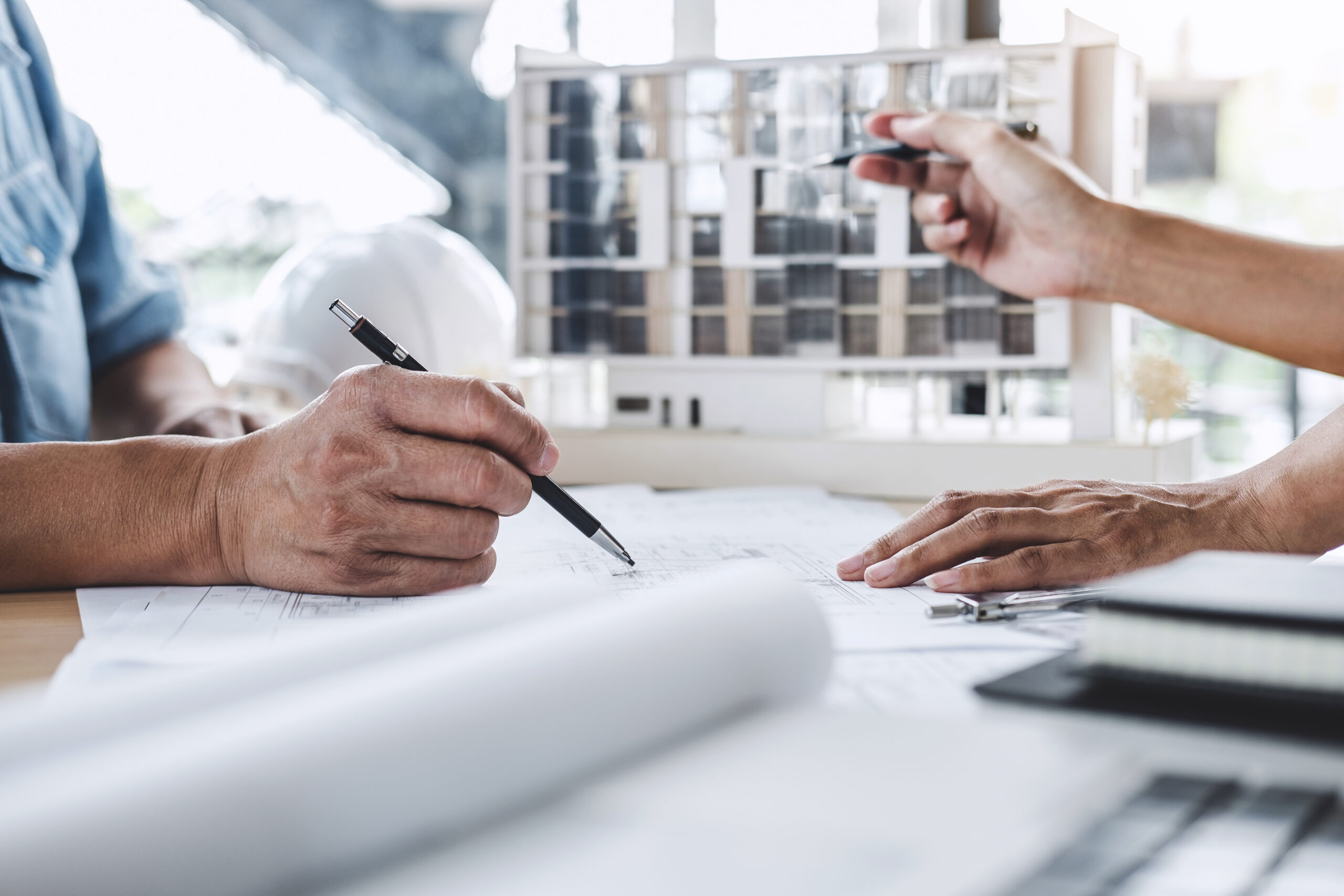 Construction and structure concept of Engineer or architect meeting for project working with partner and engineering tools on model building and blueprint in working site.
